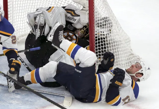 St. Louis Blues' Jaden Schwartz, front, ends up on his back and Boston Bruins goaltender Tuukka Rask, of Finland, ends up in the net during the second period in Game 2 of the NHL hockey Stanley Cup Final, Wednesday, May 29, 2019, in Boston. (Photo by Charles Krupa/AP Photo)