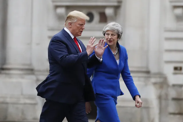 President Donald Trump walks with British Prime Minister Theresa May to a news conference at the Foreign Office, Tuesday, June 4, 2019, in central London. (Photo by Alex Brandon/AP Photo)