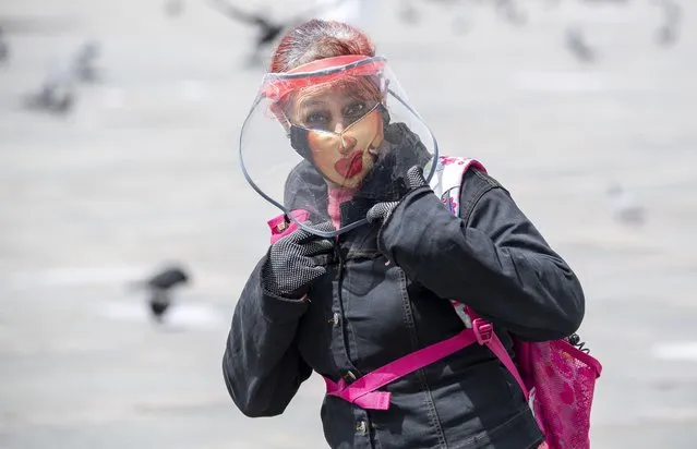 A woman wears a face mask and shield in Bogota on January 26, 2021, amid the new coronavirus pandemic. (Photo by Juan Barreto/AFP Photo)