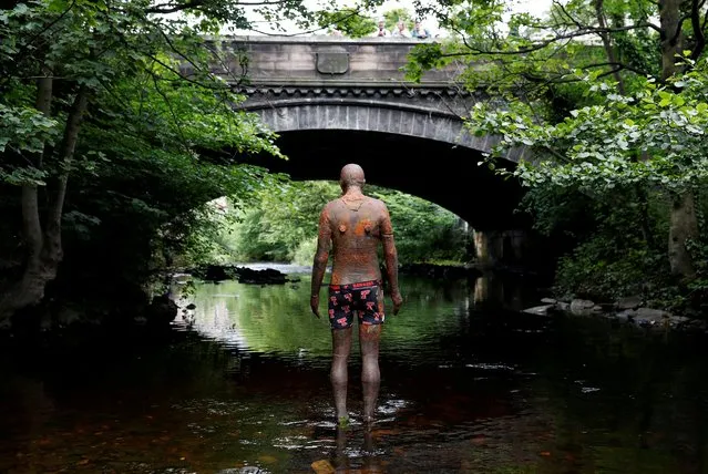 An Antony Gormley statue with an underwear on it stands in the Water of Leith Stockbridge, Edinburgh, Scotland, Britain on June 22, 2019. (Photo by Russell Cheyne/Reuters)