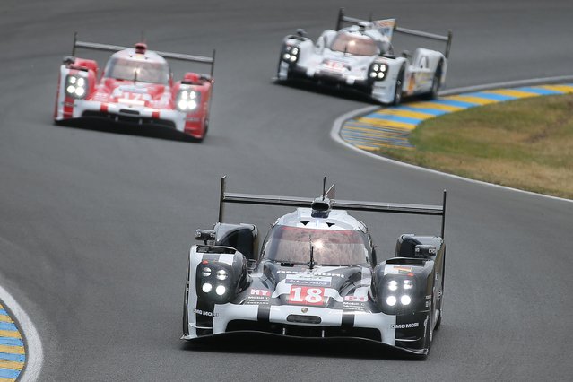 The Porsche 919 Hybrid No18 of the Porsche Team driven by Neel Jani of Switzerland leads the pack at the start of the 83rd 24-hour Le Mans endurance race, in Le Mans, western France, Saturday, June 13, 2015. (AP Photo/David Vincent)