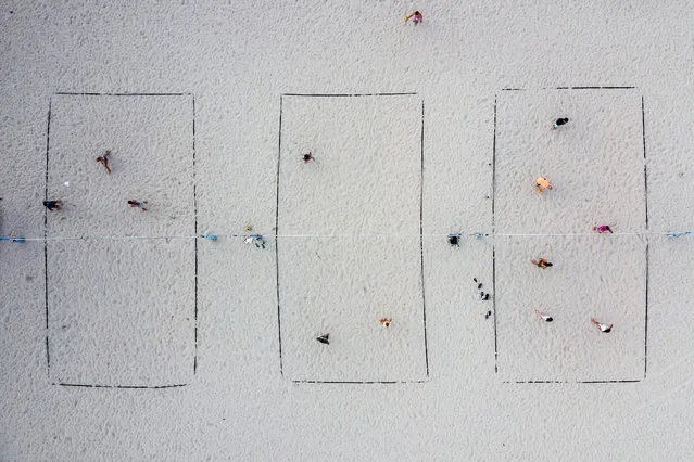 People play beach volleyball near Ocean Drive in Miami Beach, on May 17, 2021. (Photo by Chandan Khanna/AFP Photo)