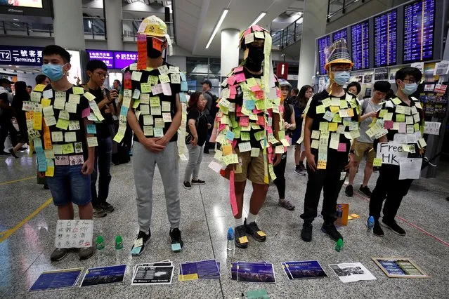 Demonstrators wear post-it notes as part of the “Lennon Wall” movement during a protest against the recent violence in Yuen Long, at Hong Kong airport, China on July 26, 2019. More protests are expected on Saturday with demonstrators outraged at an attack on July 21 at a train station by armed men who police sources say included some with backgrounds in Hong Kong's triad criminal gangs. Some 45 people were wounded. (Photo by Edgar Su/Reuters)