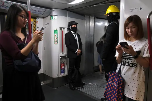 Anti-extradition bill demonstrators wearing helmets are seen inside a Mass Transit Railway (MTR) train in Hong Kong, China on July 30, 2019. (Photo by Tyrone Siu/Reuters)