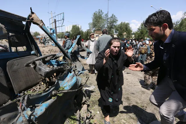 An Afghan woman cries out at the site of a suicide attack on a NATO convoy in Kabul, Afghanistan, Tuesday, June 30, 2015. (Photo by Rahmat Gul/AP Photo)