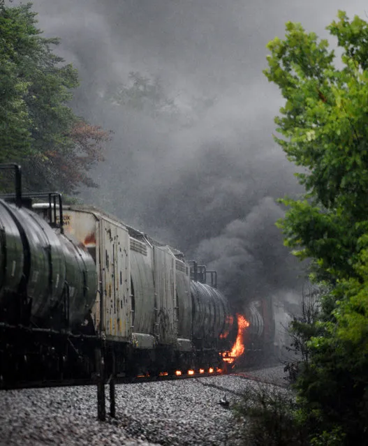 Smoke rises from a CSX train following the derailment of a train car, Thursday, July 2, 2015, in Maryville, Tenn. The derailment of the car, carrying a flammable and toxic substance, caused the evacuation of thousands in the surrounding area. (Photo by Michael Patrick/Knoxville News Sentinel via AP Photo)