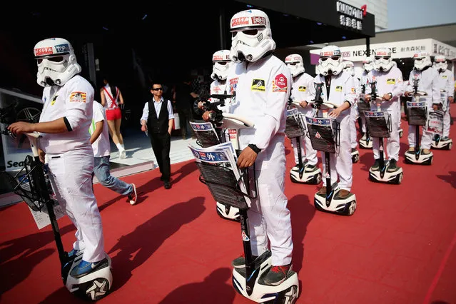 People dressed up as Imperial soldiers of Star Wars film distribute promotional manual to visitors during the 2014 Beijing International Automotive Exhibition at China International Exhibition Center on April 22, 2014 in Beijing, China. More than 2,000 automotive enterprises from 14 countries and regions participated in the 2014 Beijing International Automotive Exhibition from April 20 to April 29. (Photo by Feng Li/Getty Images)