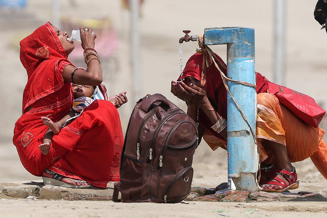 Women quench their thirst with the tap water on a hot summer afternoon during heatwave in Prayagraj on June 10, 2024. India's heatwave is the longest ever to hit the country, the government's top weather expert said on June 10 as he warned people will face increasingly oppressive temperatures. Parts of northern India have been gripped by a heatwave since mid-May, with temperatures soaring over 45 degrees Celsius (113 degrees Fahrenheit). (Photo by Anil Shakya/AFP Photo)