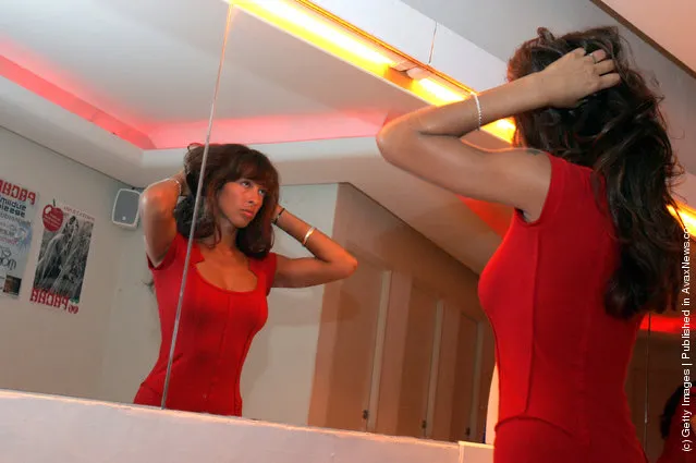 A clubber adjusts her hair in the restrooms of Pacha nightclub in Eivissa town