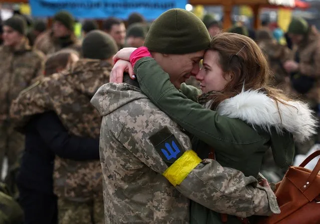 Olga hugs her boyfriend Vlodomyr as they say goodbye prior to Vlodomyr?s deployment closer to the front line, amid Russia's invasion of Ukraine, at the train station in Lviv, Ukraine, March 9, 2022. (Photo by Kai Pfaffenbach/Reuters)