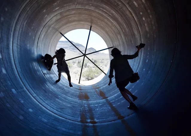 People walk through a Hyperloop tube after the first test of a propulsion system at the Hyperloop One Test and Safety site on May 11, 2016 in North Las Vegas, Nevada. The company plans to create a fully operational hyperloop system by 2020. (Photo by David Becker/Getty Images)