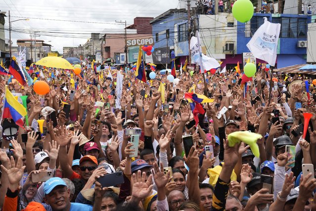 Supporters of opposition presidential candidate Edmundo Gonzalez raise their hands in unison at a campaign rally in Barinas, Venezuela, July 6, 2024. (Photo by Ariana Cubillos/AP Photo)