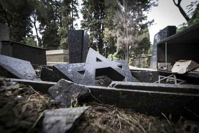 Smashed headstones lie at the Verano cemetery in Rome, Friday, May 12, 2017. Vandals have struck overnight at Rome’s main cemetery, smashing and shattering some 70 headstones and ornaments. Rome Mayor Virginia Raggi decried the vandalism as a “vile deed”.’ Officials said Catholic and Jewish headstones were among the smashed monuments. Italian news reports said investigators a group of youths who sneaked into the cemetery at night did the damage. (Photo by Massimo Percossi/ANSA via AP Photo)