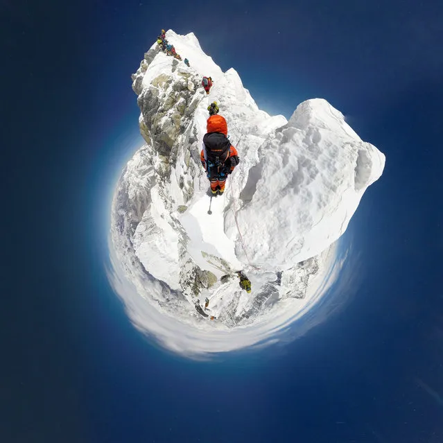 In this image released on Sunday, May 22, 2016, Swiss mountain sports specialist Mammut created a new milestone in virtual mountaineering as two Nepalese Sherpa mountain guides Pemba Rinji Sherpa and Lakpa Sherpa supported by Kusang Sherpa and Ang Kaji Sherpa became the first men in the world to document the whole South route to the summit of Mount Everest in Nepal with a 360° camera rig. They are pictured in a 360 view of the climb. Capturing the breathtaking views from the world’s highest mountain, Mammut’s #project360 has played a pioneering role in bringing the real life Mount Everest experience into peoples’ living rooms – without special effects, animations or computer generated images. (Photo by Mammut/PHOTOPRESS via AP Images)
