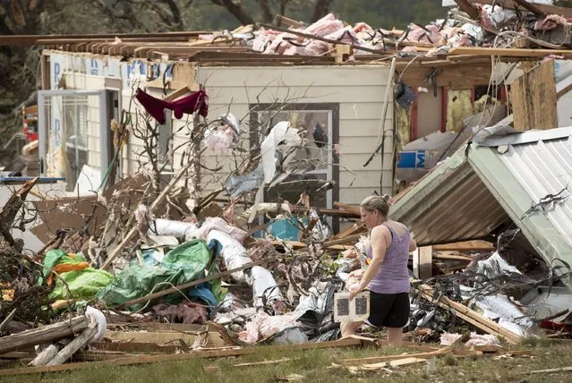 Michelle Light salvages belongings from her home on FM 2843 and Cedar Valley Road near Salado, Texas, on Wednesday, April 13, 2022, a day after a tornado destroyed the house. (Photo by Jay Janner/Austin American-Statesman via AP Photo)