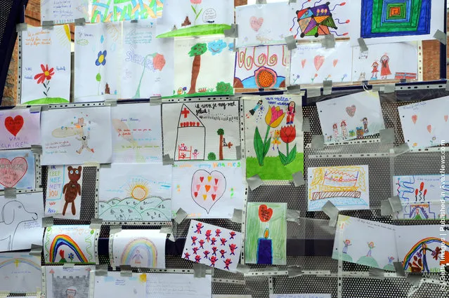 Messages and tributes drawn by school children adorn the gates of Sint Lambertus School, following a bus crash that killed 22 children in Switzerland
