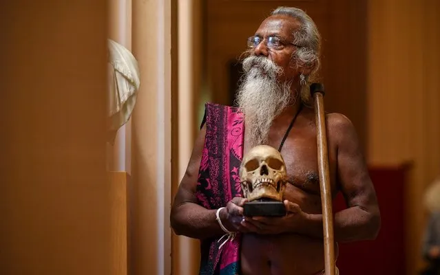 Wani Uruwarige, chief of the ancient Sri Lankan jungle dwelling tribe the Vedda people, attends a ceremony in the University of Edinburgh's Playfair Library on November 22, 2019 in Edinburgh, Scotland. The university returned a set of nine human skulls it acquired over 100 years ago and had housed in their anatomical collection. The Vedda plan to display the skulls in an exhibition back home that will showcase their traditional ways of life. (Photo by Jeff J Mitchell/Getty Images)