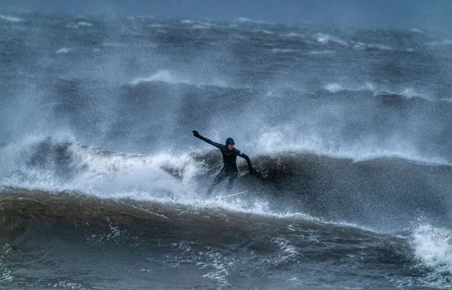 A surfer off the North East coast at Tynemouth, England on December 10, 2019. (Photo by Owen Humphreys/PA Images via Getty Images)