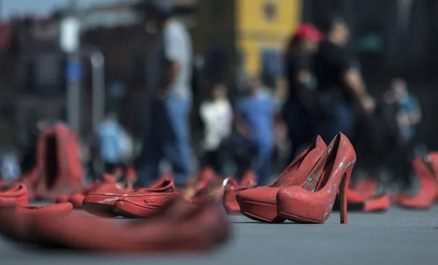 Women's red shoes are spread out in the Zocalo where they were placed by people to protest violence against women in Mexico City, Saturday, January 11, 2020. There are 10 women killed daily on average across Mexico, and only one in 10 such crimes are solved, according to the National Citizens’ Observatory on Femicide. (Photo by Christian Palma/AP Photo)