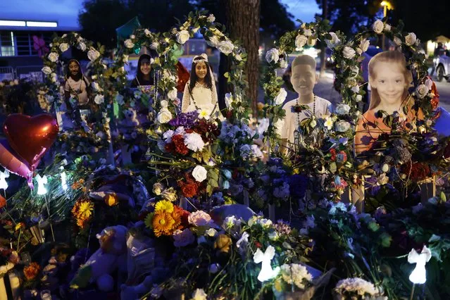 Flowers and photographs are seen at a memorial dedicated to the victims of the mass shooting at Robb Elementary School on June 2, 2022 in Uvalde, Texas. 19 students and two teachers were killed on May 24 after an 18-year-old gunman opened fire inside the school. Wakes and funerals for the 21 victims are scheduled throughout the week. (Photo by Alex Wong/Getty Images)