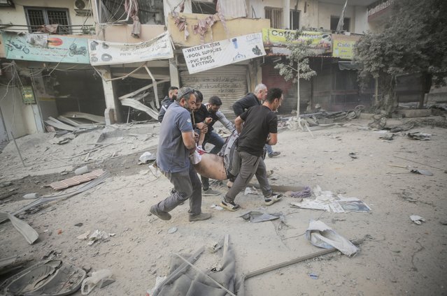 People carry a wounded man, after an Israeli strike on the Mreijeh neighbourhood in Beirut's southern suburbs, amid cross-border hostilities between Hezbollah and Israel, in Beirut, Lebanon on October 4, 2024. (Photo by Ali Alloush/Reuters)