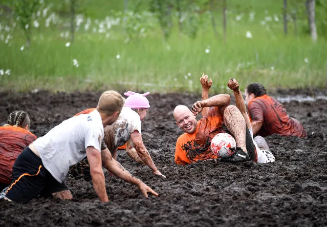 Players in action during the Swamp Soccer Championships 2017 in Hyrynsalmi, Finland, 14 July 2017. The world championship in swamp football is played annually on the Vuorisuo bog in Hyrynsalmi, the first took place in 2000. There are 20 fields in Vuorisuo, and during the competition nearly 1,000 games are played. (Photo by Kimmo Brandt/EPA)