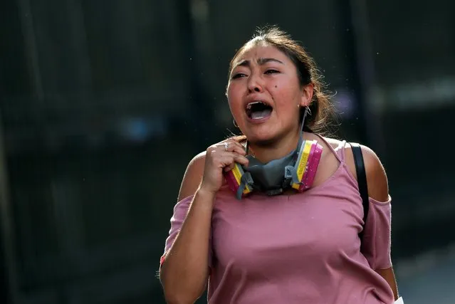 A woman reacts during an anti-government protests in Santiago, Chile on October 28, 2019. (Photo by Henry Romero/Reuters)