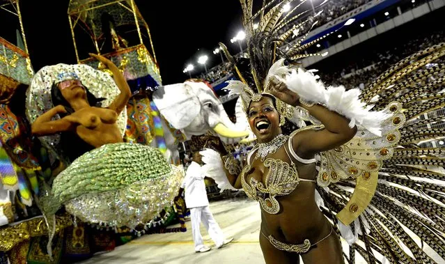 A reveller of the Nene de Vila Matilde samba school dances ahead of a float during at the Sambadrome in Sao Paulo