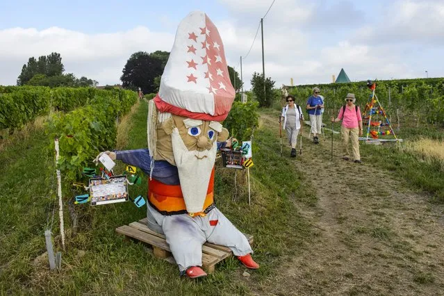 A scarecrow is on display during the 5th edition of the biannual scarecrow competition, in which the residents of Denens fashion scarecrows of all kinds, in Denens, Switzerland, 11 August 2015. (Photo by Jean-Christophe Bott/EPA)