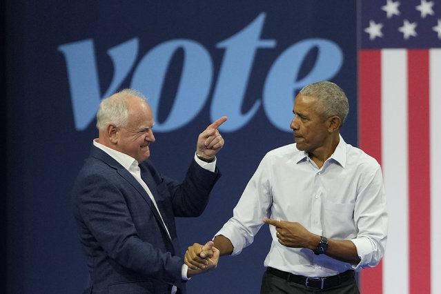 Democratic vice presidential nominee Minnesota Gov. Tim Walz, left, and former President Barack Obama shake hands at a campaign event Tuesday, October 22, 2024, in Madison, Wis. (Photo by Morry Gash/AP Photo)