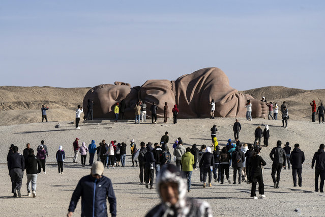 Visitors walk towards a statue at the Son of Earth Sculpture Park in Jiuquan, Gansu Province, China, on Wednesday, October 16, 2024. China's central bank moved to support markets just as data showed the economy expanding the least in six quarters, signaling the government's intent to continue a stimulus push to draw a line under the slowdown. (Photo by Qilai Shen/Bloomberg)