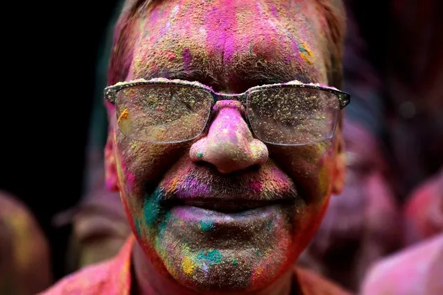 A man daubed in colors looks on as he takes part in “Lathmar Holi” celebrations in the town of Barsana, in the northern state of Uttar Pradesh, India, March 4, 2020. (Photo by Adnan Abidi/Reuters)