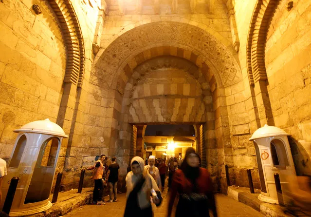 People walk through the historic Zuwayla, or “Bab Zuwayla” after their iftar (breaking fast) meal during the Muslim fasting month of Ramadan, in old Cairo, Egypt June 16, 2016. (Photo by Amr Abdallah Dalsh/Reuters)