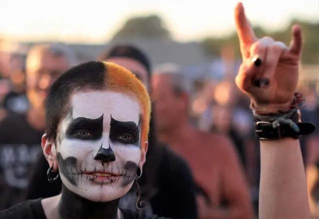 A festival goer cheers during the Wacken Open Air 2022 heavy metal festival in Wacken, Germany on August 3, 2022. (Photo by Thilo Schmuelgen/Reuters)