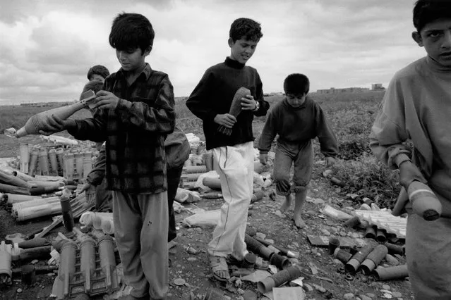 Children are often the casualties of left-behind war ordnance. The day after this photograph was taken in Kirkuk, three of the children pictured died after putting a bomb they had collected into a fire. (Photo by Sean Sutton for the Mines Advisory Group/The Guardian)