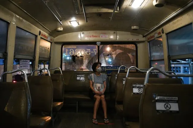 A woman wearing a protective face mask due to coronavirus disease (COVID-19) outbreak, sits on a social distancing seat as she rides a bus in Bangkok, Thailand, March 27, 2020. (Photo by Chalinee Thirasupa/Reuters)