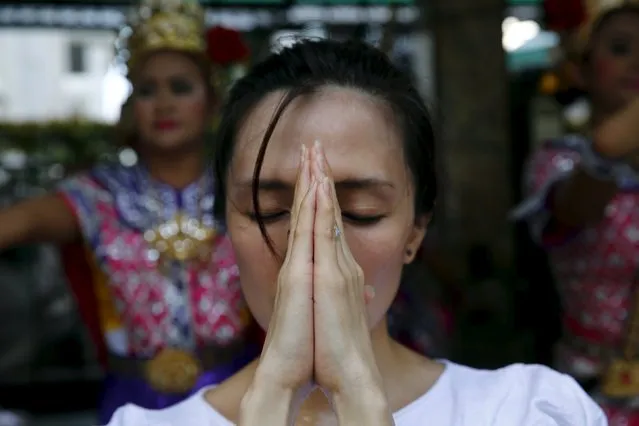 A woman prays at Erawan Shrine, the site of the recent bomb blast, in Bangkok August 30, 2015. (Photo by Jorge Silva/Reuters)