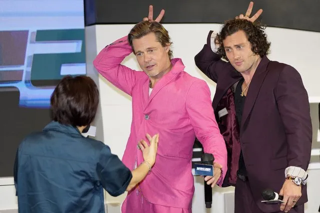Actors Brad Pitt and Aaron Taylor-Johnson gesture during the red carpet event to promote their latest movie “Bullet Train” in Seoul, South Korea, Friday, August 19, 2022. The movie is to be released in the country on Aug. 24. (Photo by Lee Jin-man/AP Photo)