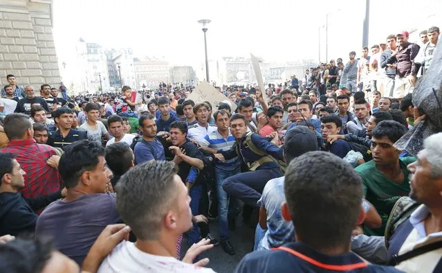 A group of migrants fights with others trying to make their way through the crowd to the Eastern railway station in Budapest, Hungary, September 2, 2015. Hundreds of migrants protested in front of Budapest's Eastern railway station on Wednesday, shouting “Freedom, freedom!” and demanding to be let onto trains bound for Germany but the station remained closed to them. More than 2,000 migrants, including families with children, were waiting in the square at the station in sweltering heat. (Photo by Laszlo Balogh/Reuters)