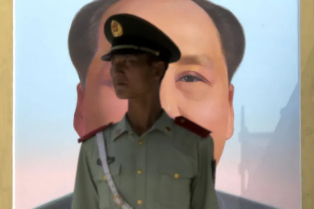 A Chinese paramilitary policeman stands watch against the portrait of the late Chinese leader Mao Zedong on Tiananmen Gate in Beijing, Friday, September 1, 2017. China said a key Chinese Communist Party meeting held once every five years will start on Oct. 18, marking the formal countdown to the gathering at which President Xi Jinping will begin his second five-year term as head of the ruling party. (Photo by Andy Wong/AP Photo)