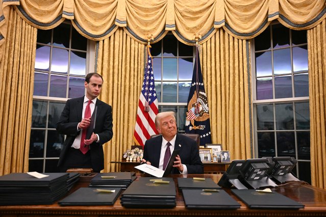 US President Donald Trump signs executive orders in the Oval Office of the WHite House in Washington, DC, on January 20, 2025. (Photo by Jim Watson/Pool via AFP Photo)