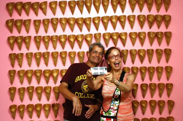 Visitors pose at the Museum of Ice Cream across from the Whitney Museum on July 29, 2016 in New York City. The temporary museum dedicated to all things ice cream will be open for the month of August. (Photo by Kena Betancur/Getty Images)