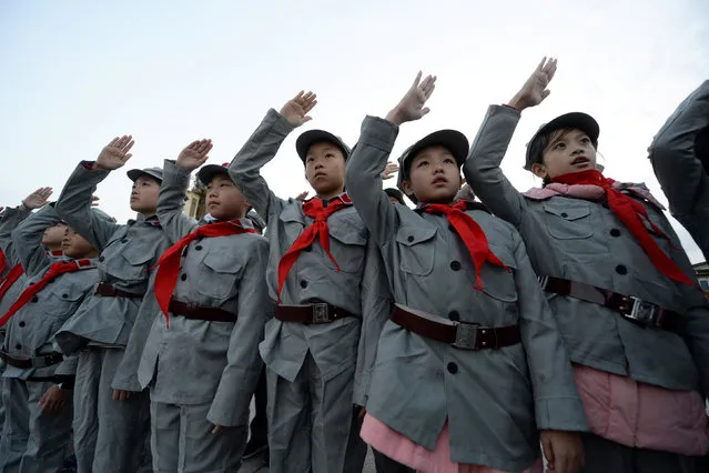 Primary school students dressed in replica red army uniforms attend a flag-raising ceremony at Tiananmen Square in Beijing, China October 14, 2017. (Photo by Reuters/China Stringer Network)