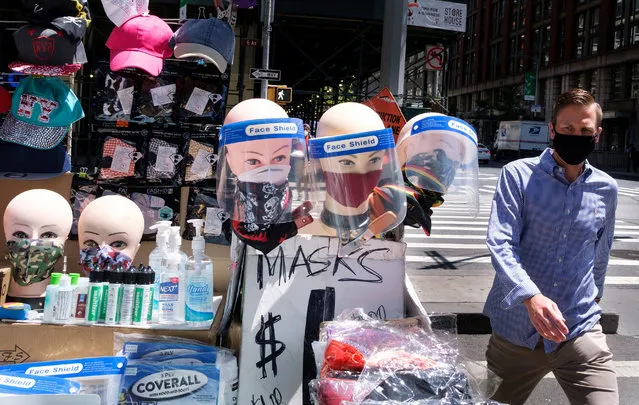 A man walks past masks and face shields for sale on a street corner in New York, New York, USA, 27 May 2020. As restrictions put in place during the coronavirus pandemic are slowly lifted around the country, people are being asked to wear masks in public and navigate how much personal protection equipment they feel they to feel safe around other people. (Photo by Justin Lane/EPA/EFE/Rex Features/Shutterstock)