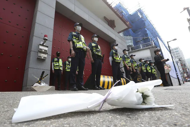 A flower for victims of Tiananmen crackdown is laid as police officers stand guard  in front of the Chinese Embassy in Seoul, South Kore, Thursday, June 4, 2020 during a rally marking the 31st anniversary of the Tiananmen crackdown on pro-democracy activists in Beijing. (Photo by Ahn Young-joon/AP Photo)