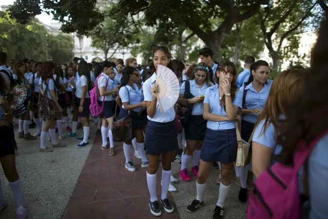 Pre-university students chat at a park in Havana during the first day of class of the 2015-2016 course, September 1, 2015. (Photo by Alexandre Meneghini/Reuters)