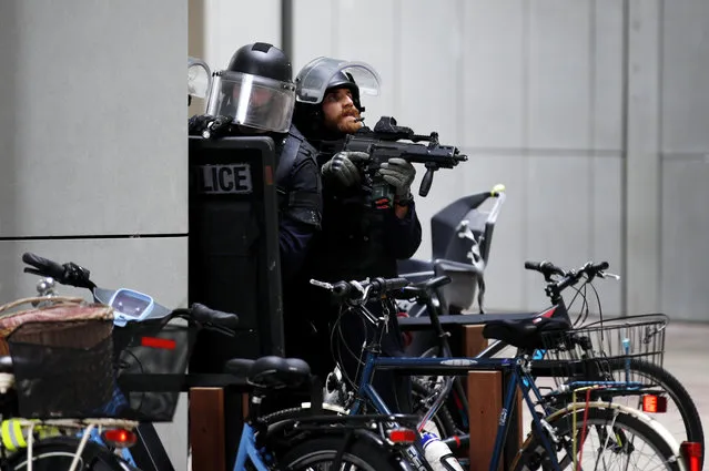 French police officers patrol at La Defense business district following reports of a gunman near Paris, France, 30 June 2020. Police evacuated hundreds of people with hands up from the Les Quatre Temps shopping centre around 9.30am after a shop worker reported seeing a masked man carrying a rifle or shotgun. The police operations ended after confirmation it was a false alarm. (Photo by Yoan Valat/EPA/EFE)