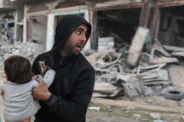 A Palestinian carries an injured child following an Israeli strike, in Beit Lahia in the northern Gaza Strip on March 19, 2025. (Photo by Abd Elhkeem Khaled/Reuters)