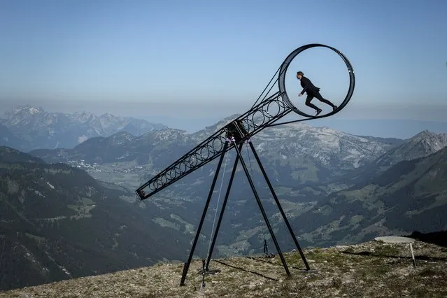 Swiss acrobat Ramon Kathriner performs with the Wheel Of The Death during the Glacier 3000 Air show an event marking the reopening of the Alpine facilities on June 23, 2020 above Les Diablerets following the lockdown due to the COVID-19 outbreak, caused by the novel coronavirus. (Photo by Fabrice Coffrini/AFP Photo)