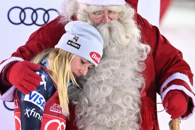 Mikaela Shiffrin of the U.S. celebrates after winning the women's slalom competition with Santa Claus during the FIS Ski World Cup in Levi, Finland on November 20, 2022. (Photo by Jussi Nukari/Lehtikuva via Reuters)